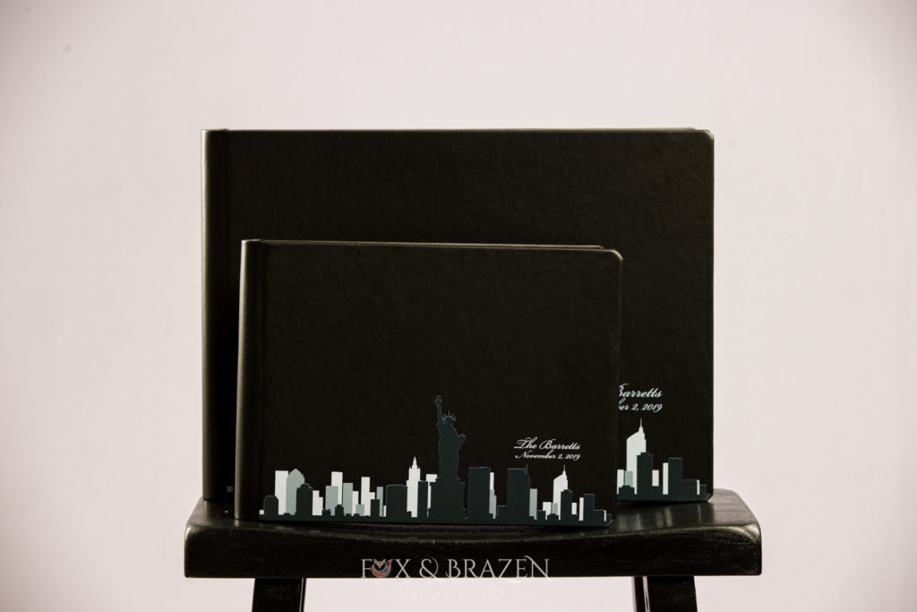 Black wedding album with companion album showcasing the New York City Skyline