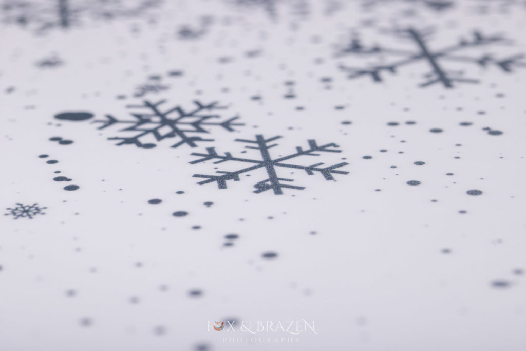 Snowflakes printed on white metal cover