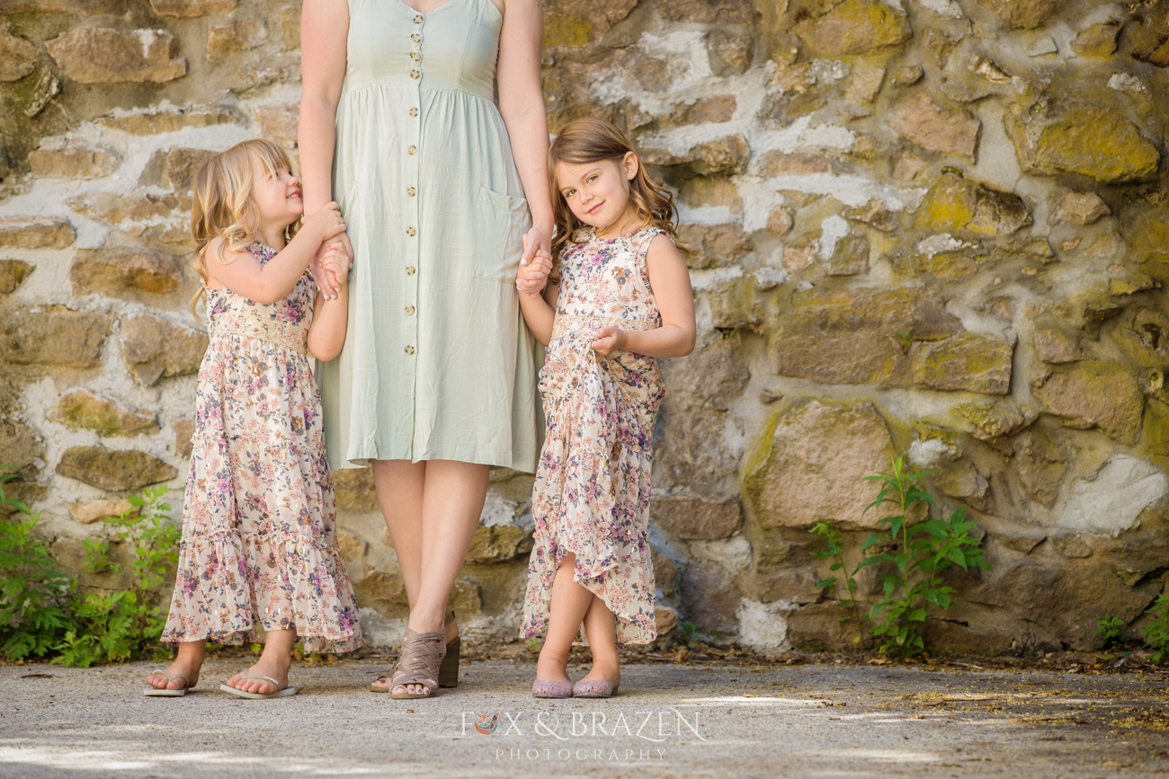 Sisters Holding Mom's Hands at Mini Session