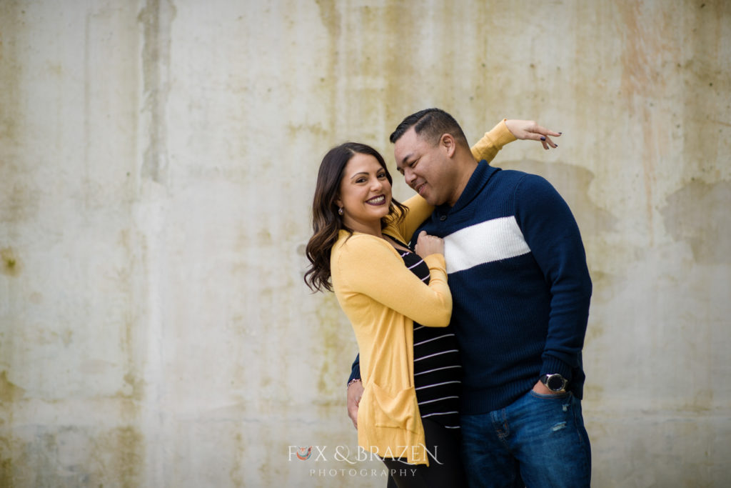 Couple laughs together at mini session