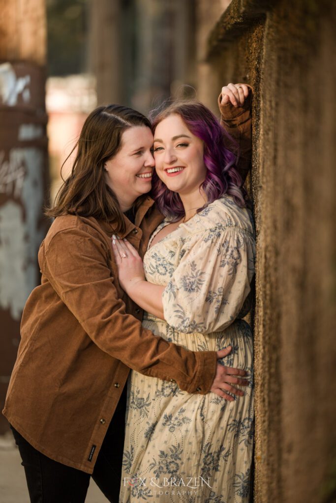 Bride-to-be touching her cold nose to her partner’s cheek.