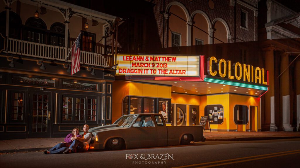 Mini truck with engaged couple and Colonial Theater marquee in Phoenixville