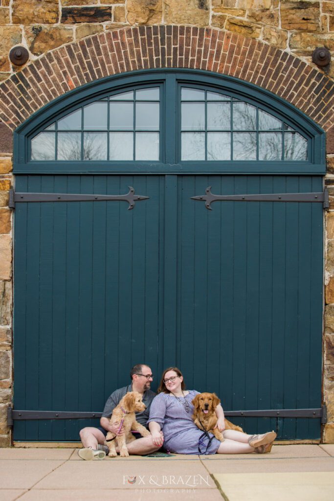 Couple with dogs in front of Phoenixville Foundry doors