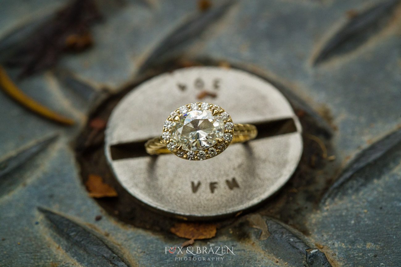 Engagement ring resting on Phoenixville iron bridge bolt