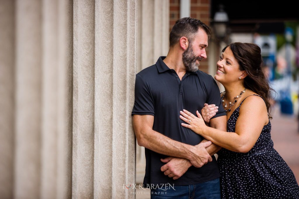 Couple leaning on Colonial Theater pillars in Phoenixville