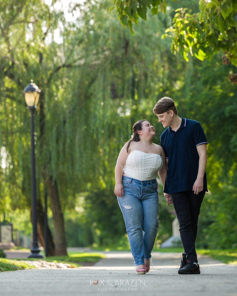Engaged couple walking Schuylkill River Trail in Phoenixville