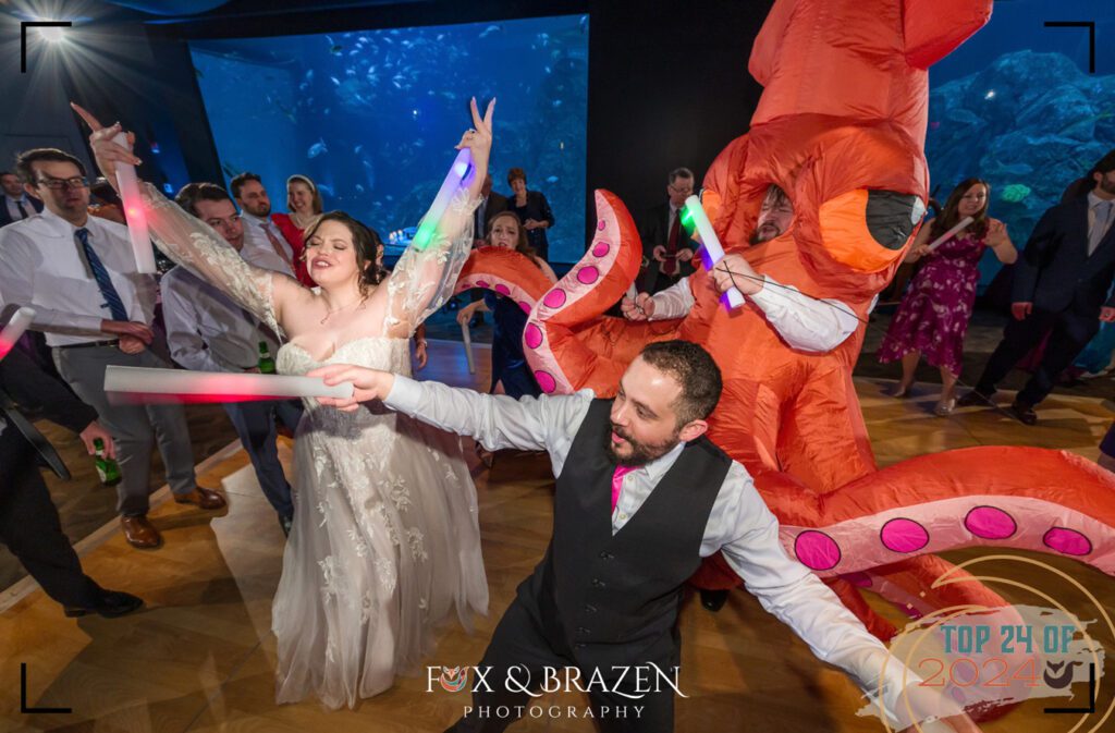 Wedding couple dancing under a giant octopus at Adventure Aquarium.