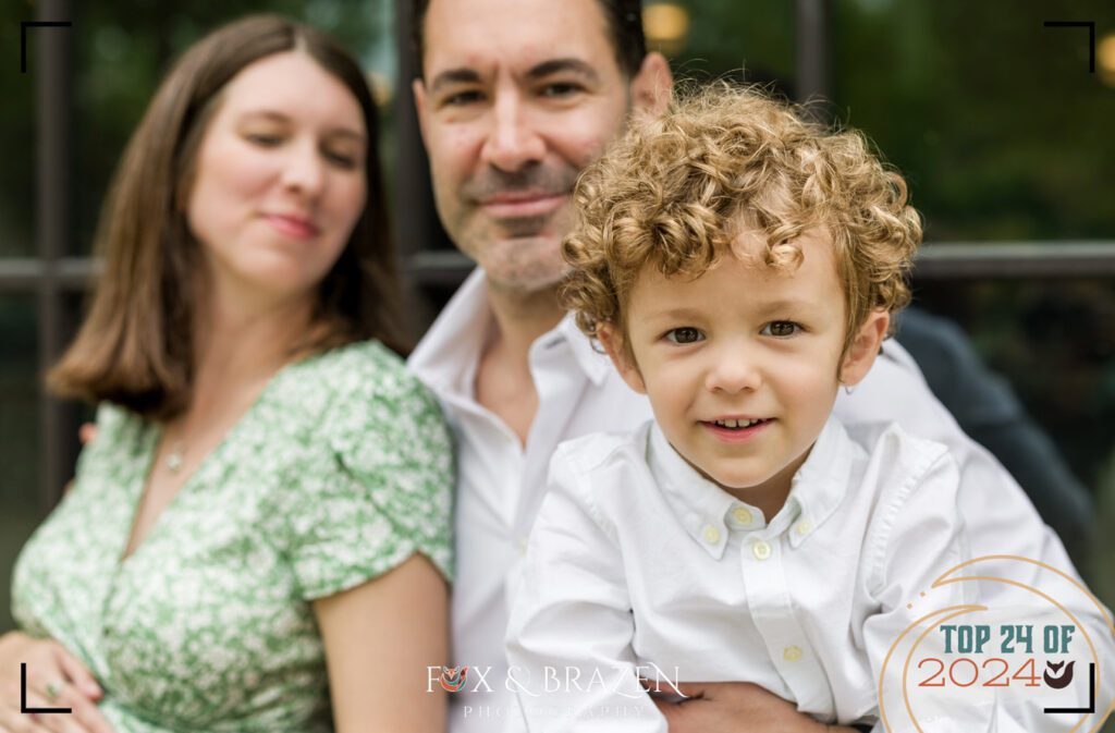 Family maternity photo with a playful sibling at Longwood Gardens.