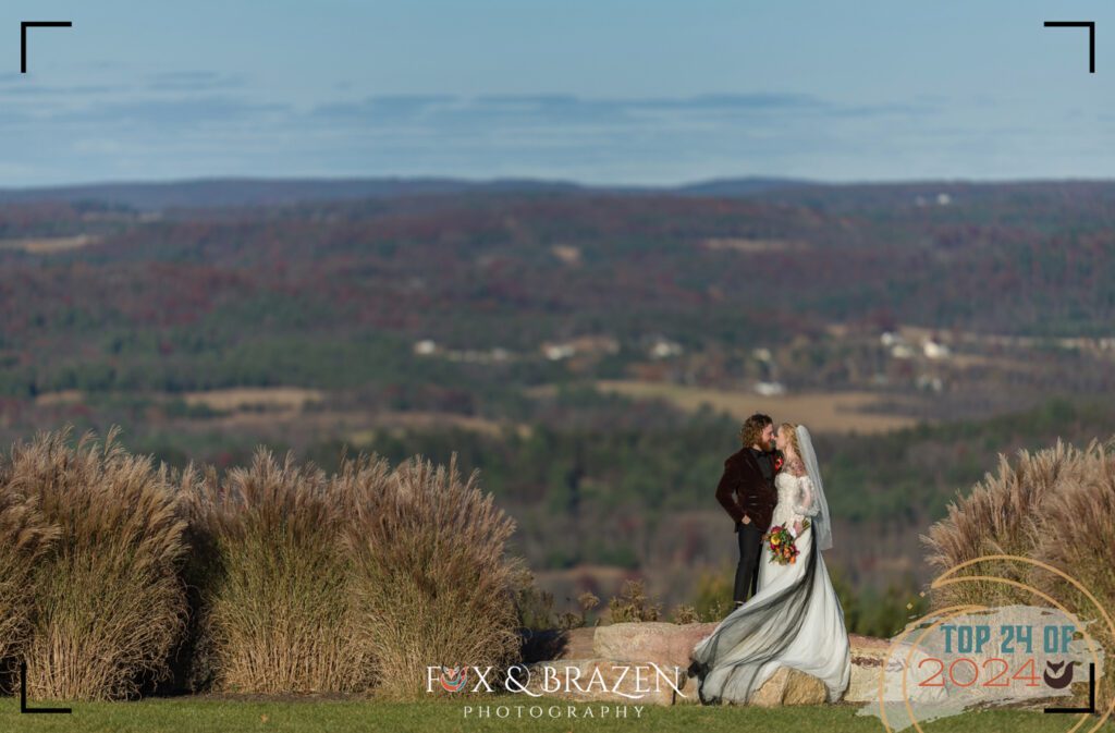 Bride and groom kiss with November sky over Lehigh Valley.