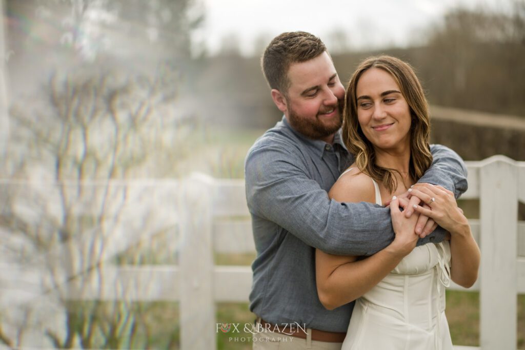 Couple embracing during engagement photos at Valley Forge.