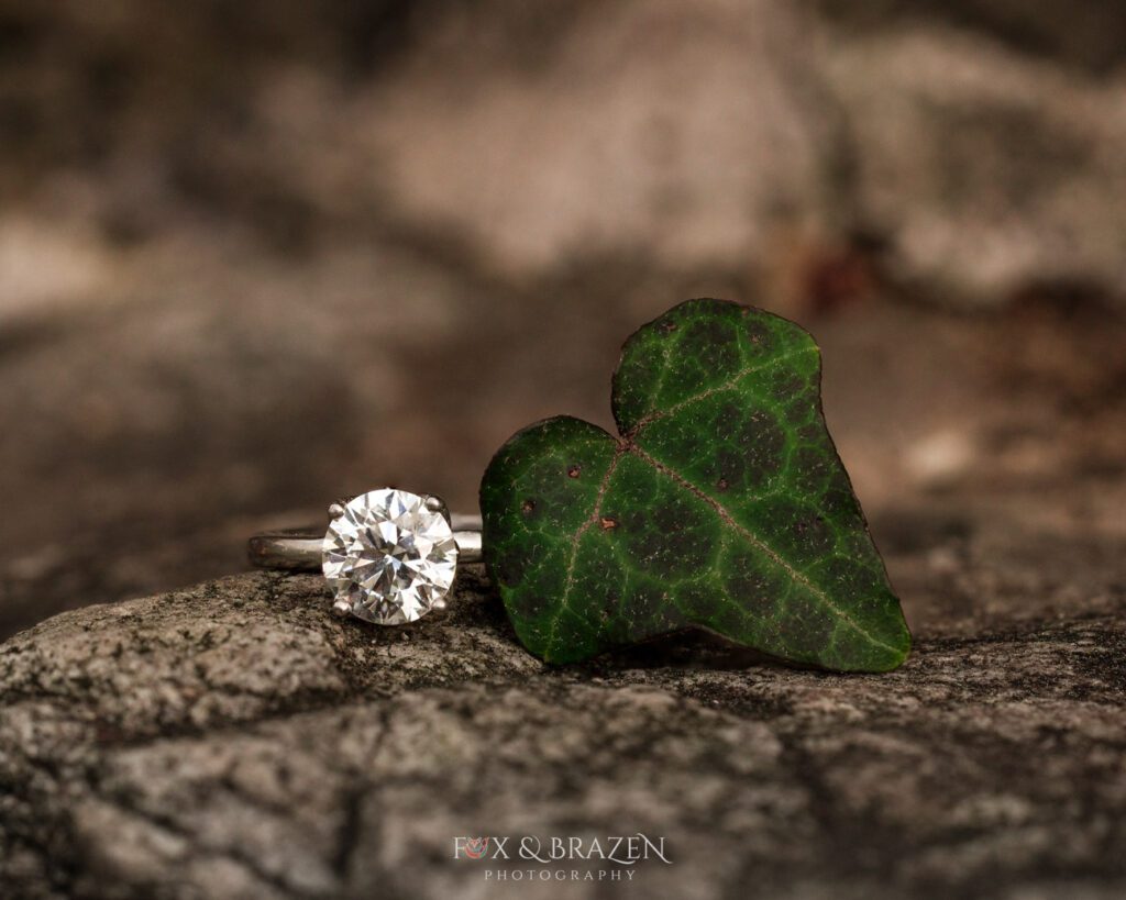 Close-up of engagement ring with a heart-shaped leaf.