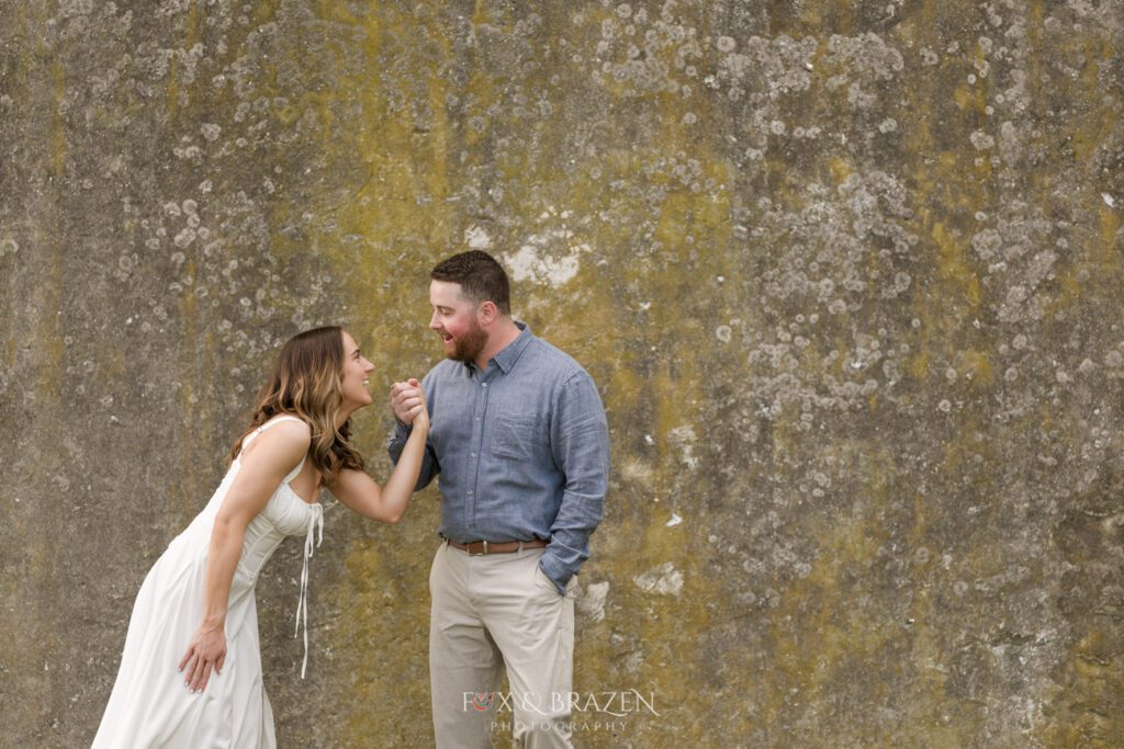 Couple laughing together during engagement photos.