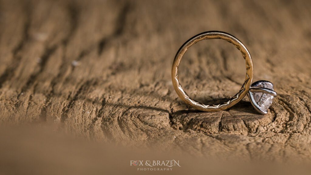 Macro closeup of engagement ring on wood at Valley Forge engagement session.