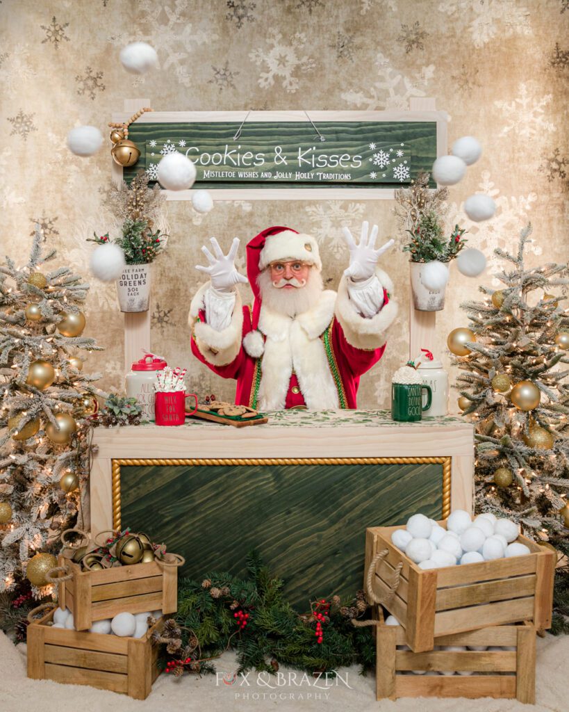 Santa Claus in a hot cocoa booth with a "Cookies & Kisses" sign, throwing snowballs at the camera.